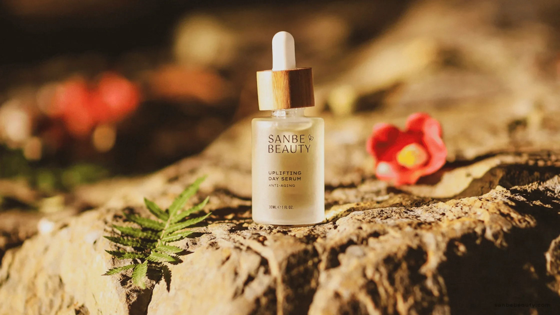 Uplifting Face Serum on a rock in evening sun light